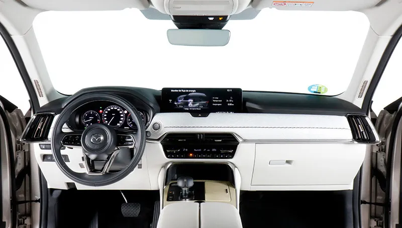 Interior del Mazda CX-60 blanco en oferta de renting, con salpicadero moderno, volante multifunción y asientos delanteros e…