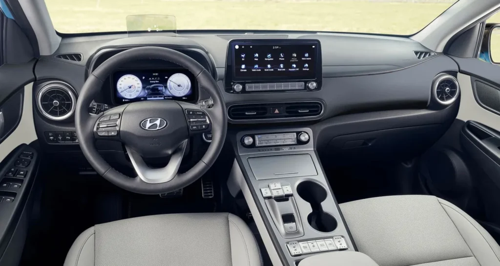 Interior del Hyundai Kona blanco en oferta de renting, vista del salpicadero moderno con pantalla central y volante multifun…